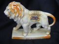 10782 Unmarked Crested China Lion in yellow lustre, with lucky white heather from Bournemouth